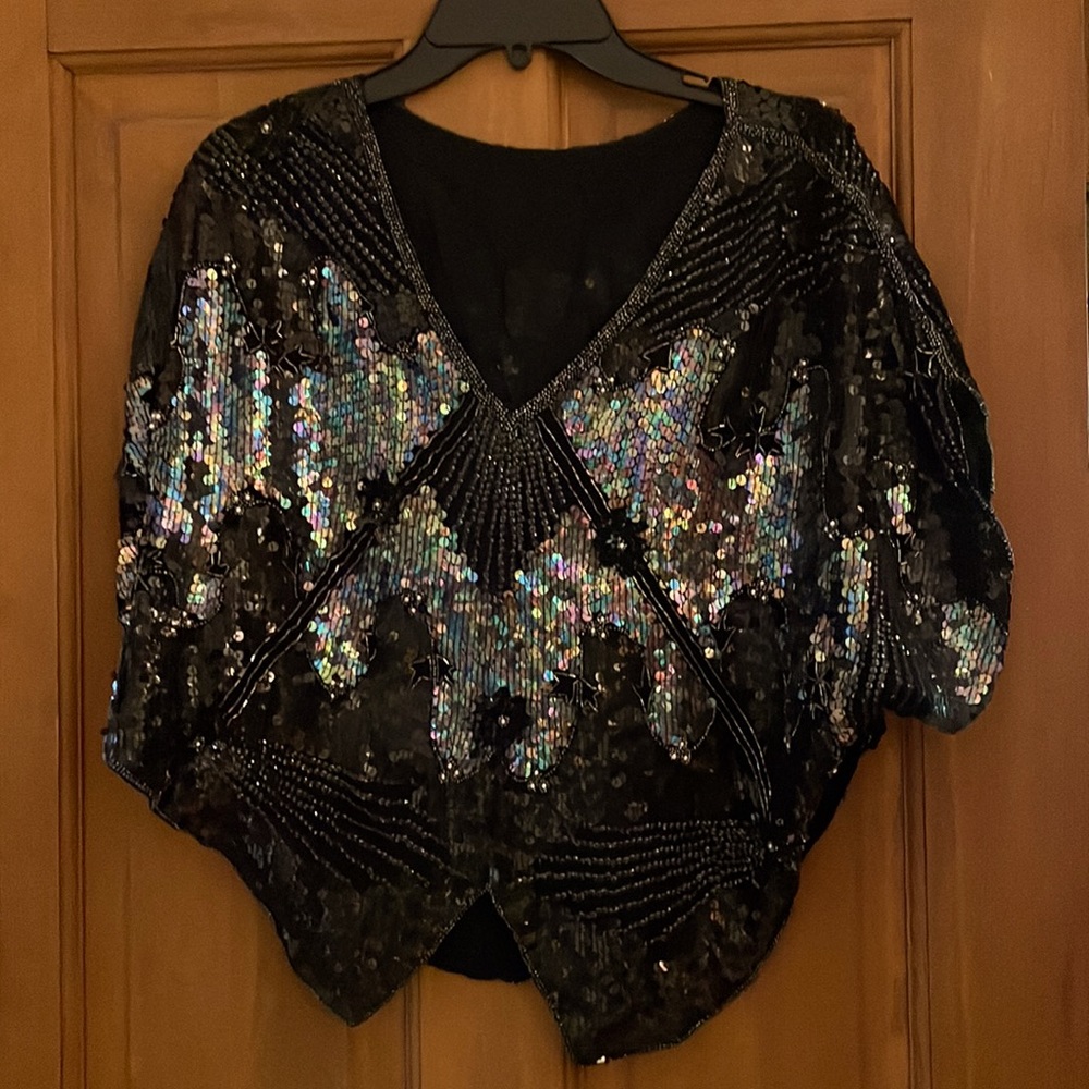 Sequined black. Paillettes and pearls catch the light for a stunning effect.
